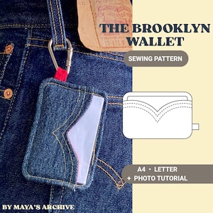 May include: A dark blue denim wallet with a V-shaped pocket design, attached to a silver carabiner. The text reads THE BROOKLYN WALLET SEWING PATTERN, A4 LETTER + PHOTO TUTORIAL, and BY MAYA'S ARCHIVE. A white line drawing of the wallet is included.
