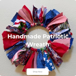 May include: A circular rag wreath constructed from various fabric strips in red, white, and blue patterns, including stars and stripes. The text "Handmade Patriotic Wreath" is centered on the image, with a "Shop Now" button at the bottom.