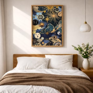 May include: A rectangular wall art print featuring a dark blue celestial scene with golden suns, moons, stars, planets, and clouds. The artwork displays various phases of the moon, stylized suns with faces, and swirling cosmic patterns in gold and blue.