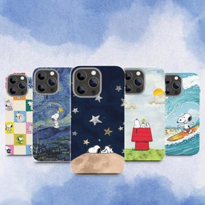 May include: Five smartphone cases featuring Snoopy in various scenes: a checkered pattern, a starry night sky, Snoopy sleeping on the moon, sitting on a red doghouse, and surfing on a wave. Each case has a cutout for a triple-lens camera system.