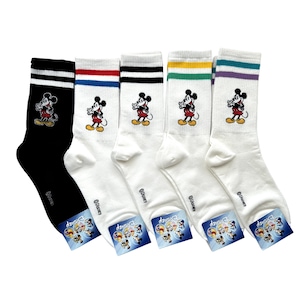 May include: A set of five crew socks featuring Mickey Mouse graphics. One sock is black with white stripes, while the others are white with various coloured stripes at the top. Each sock displays the Disney logo and a small Mickey Mouse character.