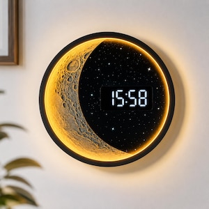 May include: A circular wall clock featuring a textured, golden crescent moon design on one side and a black starry night sky on the other. The clock face displays the digital time 15:58 in white numerals, surrounded by a warm, glowing circular light border.