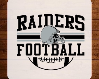 May include: A DTF transfer sheet featuring the text READY TO PRESS at the top and DTF TRANSFER at the bottom. The central graphic displays the word RAIDERS in black, a silver football helmet, and the word FOOTBALL in black above a football icon.