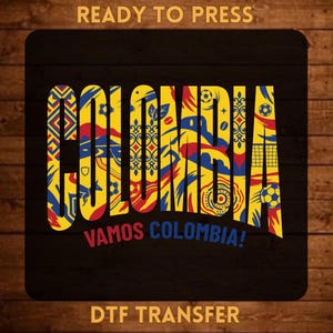 May include: A DTF transfer sheet featuring the word COLOMBIA in large yellow, blue, and red block letters. The design includes soccer balls, geometric patterns, and the text READY TO PRESS, VAMOS COLOMBIA!, and DTF TRANSFER in yellow.