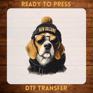 May include: A DTF transfer print featuring a beagle wearing a black beanie with the text NEW ORLEANS and black sunglasses. The dog is dressed in a black hooded sweatshirt. The image includes the text READY TO PRESS and DTF TRANSFER.