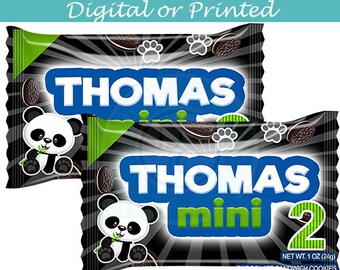 May include: Two black and green cookie packages with a panda bear design. The packages are labeled "THOMAS mini" and "THOMAS mini 2".