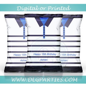 May include: Three white and blue striped treat bags with a blue and black polo shirt design. The bags have the text "Happy 15th Birthday Adrien" printed on them.