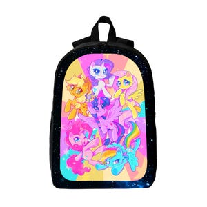 May include: A black backpack featuring a vibrant graphic print of six colorful ponies on a starburst background. The design includes characters in shades of pink, yellow, purple, blue, and orange, surrounded by a dark space-themed border.