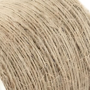 May include: A close-up of a spool of natural twine. The twine is a light beige color and is wound tightly around the spool.