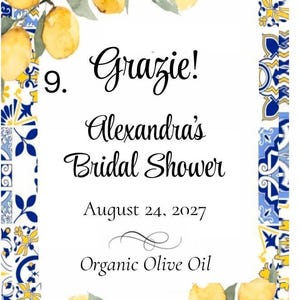 Puede incluir: Una tarjeta blanca con un borde decorativo con limones amarillos y patrones de azulejos azules y amarillos. La tarjeta dice "Grazie! Alexandra's Bridal Shower August 24, 2027 Organic Olive Oil."