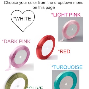 May include: Assortment of satin ribbon spools in various colors, including white, light pink, dark pink, red, olive, and turquoise. Each spool is 1/4 inch wide.