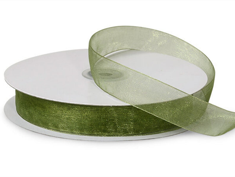 May include: A spool of olive green sheer ribbon with a shimmery finish.
