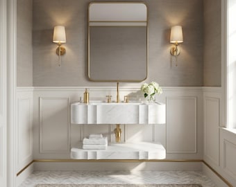 May include: A wall-mounted white marble vanity with a double-tier design, featuring a gold faucet and hardware. Above the vanity is a rectangular gold-framed mirror flanked by two gold wall sconces with white shades, set against paneled walls.