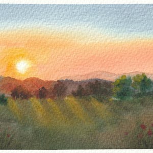 May include: A watercolor painting depicting a landscape at sunset with a bright yellow sun, soft orange and blue sky, rolling hills in the background, dark green trees, and a grassy foreground with small red flowers. The signature sai is in the corner.
