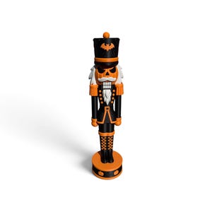 May include: A nutcracker figure featuring a black and orange color scheme. The head is a carved pumpkin with a bat emblem on the hat. It wears a black uniform with orange trim, white hair, and stands on a circular base decorated with small pumpkin icons.