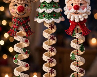 May include: Three hanging crochet ornaments featuring a reindeer, a Christmas tree, and Santa Claus. Each figure has a long, cream-colored spiral tail decorated with small festive accents and finished with two round ornaments at the bottom.