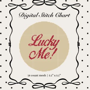 May include: A digital stitch chart featuring the text Lucky Me! in red cross-stitch style on a beige circular background. The design is framed by a black border with bows and a white background with black dots. Text includes 18 count mesh | 5.1" x 5.1".