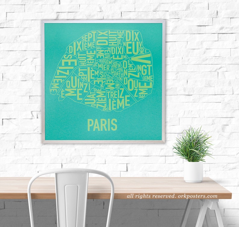 May include: A turquoise blue poster with a map of Paris, France. The map is made up of the names of the different arrondissements, or districts, of the city. The text is in yellow and the poster has a silver frame.