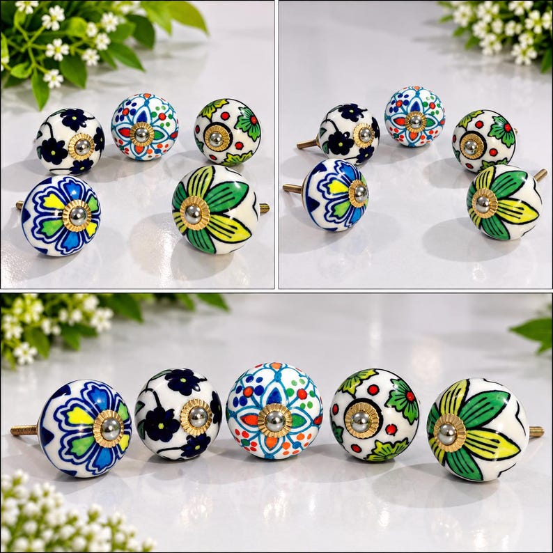 May include: A collection of round ceramic cabinet knobs featuring various hand-painted floral and geometric patterns in vibrant shades of blue, green, red, and yellow, each finished with a central metallic screw and a decorative brass-toned metal base.