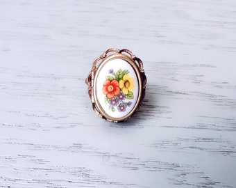 Floral Locket Ring, 1975 Vintage Avon Ring, Whimsical White Porcelain Cameo with Colorful French Flowers, Gold Tone 70s Adjustable Ring