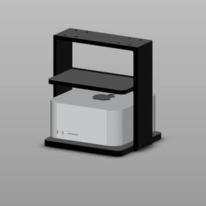 May include: A black metal computer stand with a rectangular frame and a middle shelf, holding a silver square computer with a visible Apple logo on the top surface. The stand features a flat base and a top plate with pre-drilled mounting holes.