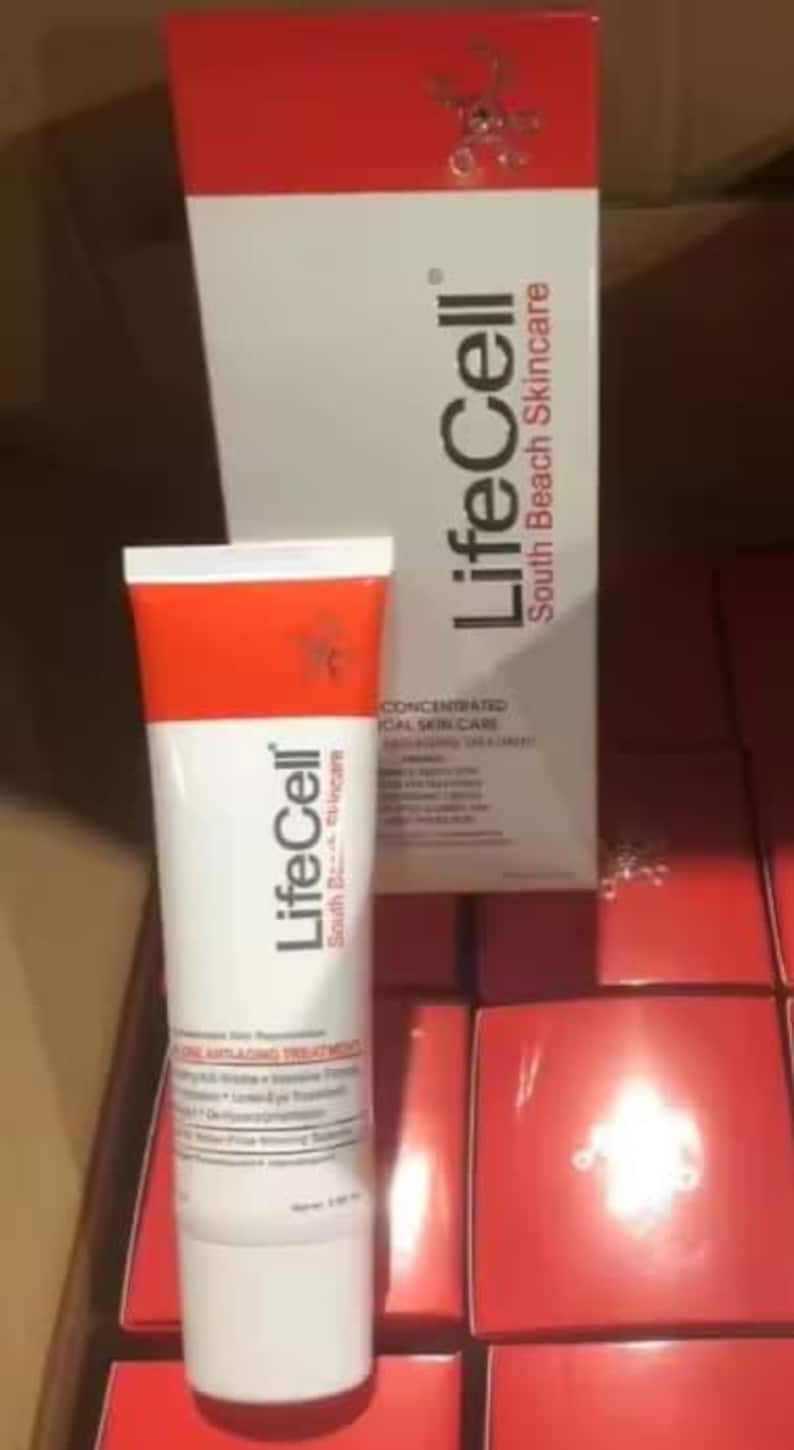 May include: A white and red LifeCell South Beach Skincare tube and its matching tall rectangular box. The packaging features black text, including the brand name LifeCell and the description All-in-One Anti-Aging Treatment, with a red top section.