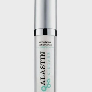 May include: A cylindrical skincare bottle with a silver cap and a clear body. The label reads ALASTIN SKINCARE, RESTORATIVE SKIN COMPLEX, with TriHex Technology, and 1.0 Fl. Oz. 29.6 mL. The design features a teal hexagonal logo graphic.