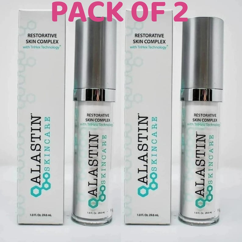May include: A pack of two Alastin Skincare Restorative Skin Complex bottles and their matching white boxes. Each bottle and box features the text Restorative Skin Complex with TriHex Technology and 1.0 Fl. Oz. 29.6 ml printed on the front.