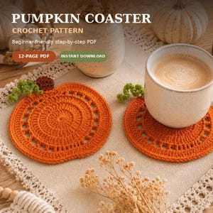 May include: A digital product listing for a PUMPKIN COASTER CROCHET PATTERN. The image displays two round, orange crocheted coasters with green stems, one holding a ceramic mug filled with a beige beverage, alongside text details.