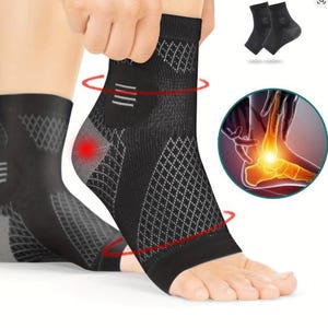 May include: A black compression ankle sleeve featuring a textured diamond pattern, a reinforced heel area with a red highlight, and a circular inset showing an anatomical illustration of a human foot with a glowing yellow point at the ankle joint.