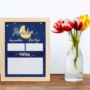 May include: A printable Ramadan calendar with a blue background and a crescent moon with stars. The calendar has spaces to fill in the day number, iftar time, and menu.