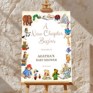 May include: A rectangular sign on a wooden easel featuring the text A New Chapter Begins, WELCOME TO, AGATHA'S BABY SHOWER, and 06.06.20XX. The border is decorated with colorful illustrations of various classic storybook characters.