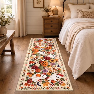 May include: A rectangular runner rug featuring a cream background with a repeating pattern of orange jack-o'-lanterns, white ghosts, colorful autumn leaves, sunflowers, red dahlias, purple flowers, small butterflies, and black bats.