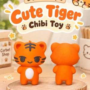 May include: Two orange tiger figurines with black stripes and a white belly patch. One figurine faces forward showing a smiling face, while the other shows the plain orange back. The text "Corbet Shop" and "Cute Tiger Chibi Toy" appear above.