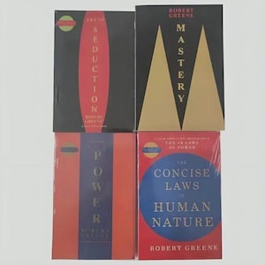 May include: Four books by Robert Greene arranged in a grid. Top left is The Art of Seduction with a red oval on black. Top right is Mastery with gold triangles on black. Bottom left is The 48 Laws of Power in red and blue. Bottom right is The Concise Laws of Human Nature with a blue circle on red.