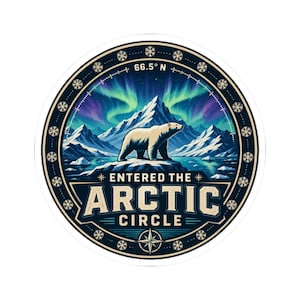 May include: A circular sticker featuring a polar bear standing on an icy landscape with snow-capped mountains and green and purple aurora borealis in the sky. The text reads 66.5 N ENTERED THE ARCTIC CIRCLE, surrounded by a border of small snowflakes.