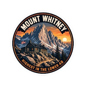 May include: A circular sticker featuring a mountain landscape with a stone cabin, a flag, and a sunset. The text reads MOUNT WHITNEY at the top and HIGHEST IN THE LOWER 48 at the bottom. The scene includes rocky terrain, pine trees, and snow-capped peaks.