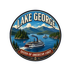 May include: A circular sticker featuring a landscape illustration of Lake George with a steamboat in the foreground, mountains in the background, and the text "LAKE GEORGE" at the top and "QUEEN OF AMERICAN LAKES" on a banner at the bottom.
