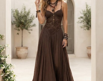 May include: A floor-length dark brown dress featuring a fitted bodice with intricate lace detailing, thin spaghetti straps, and a voluminous, pleated skirt that flows to the ankles. The garment is paired with layered beaded necklaces and bracelets.