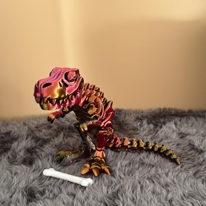 T-Rex articulado con accesorio de hueso: regalo impreso en 3D para amantes de los dinosaurios.