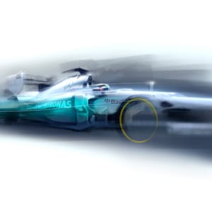 May include: A white and blue race car with a Petronas logo and a black and yellow tire. The car is blurred as it speeds down a track.