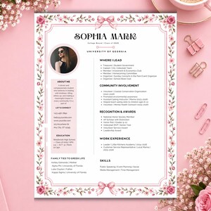May include: A resume template featuring a floral border with pink roses and a bow at the top and bottom. The document includes sections for personal information, a photo placeholder, education, skills, and experience, with the name Sophia Mark.