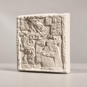 May include: A rectangular off-white stone relief plaque featuring a detailed bas-relief carving of a Mayan figure in ornate headdress and attire, standing beside a stylized serpent creature, with intricate hieroglyphic blocks in the corners.