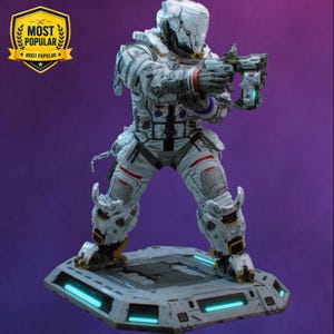 May include: A white and grey sci-fi astronaut figurine in a tactical suit with red accents, holding a futuristic weapon. The figure stands on a hexagonal base with glowing cyan light strips. A gold shield emblem with the text MOST POPULAR is visible.