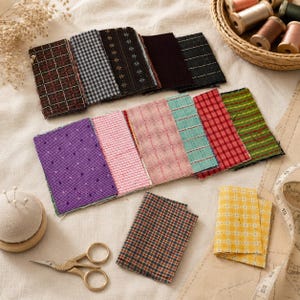 May include: A collection of rectangular fabric swatches in various colors and patterns, including plaid, checkered, and striped designs. The set includes purple, pink, red, green, yellow, and dark tones, accompanied by sewing tools and thread.