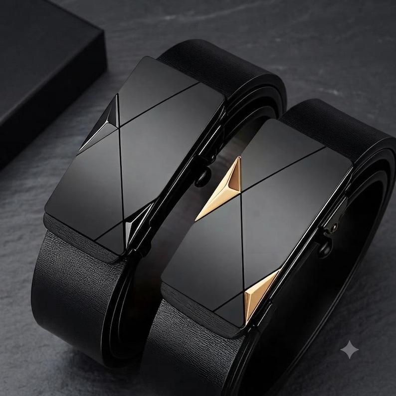 May include: Two black belts with textured straps and rectangular buckles. One buckle is solid black with geometric lines, while the other features black surfaces accented with two gold-toned triangular details on the sides of the buckle face.