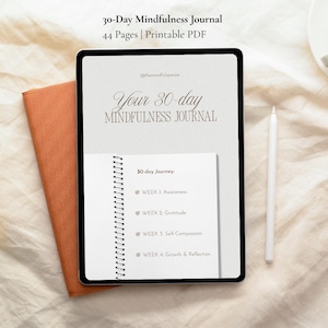 May include: A digital tablet displaying a 30-day mindfulness journal with 44 pages. The screen shows the title Your 30-day MINDFULNESS JOURNAL and a 30-day Journey list including Week 1 Awareness, Week 2 Gratitude, Week 3 Self-Compassion, and Week 4 Growth & Reflection.