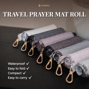 May include: A collection of rolled travel prayer mats in various shades of gray, white, and light purple, each featuring a gold-toned metal lobster clasp. The text TAZBIYA TRAVEL PRAYER MAT ROLL is visible, along with the list: Waterproof, Easy to fold, Compact, Easy to carry.