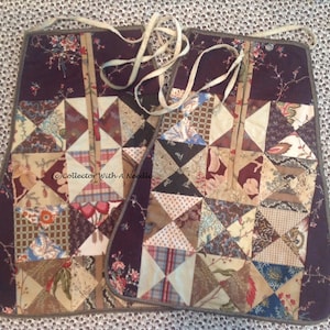 May include: Two brown and white patchwork fabric squares with a dark purple border and a white ribbon tied around them. The fabric squares are made of different patterns and colors, including floral, plaid, and geometric designs.