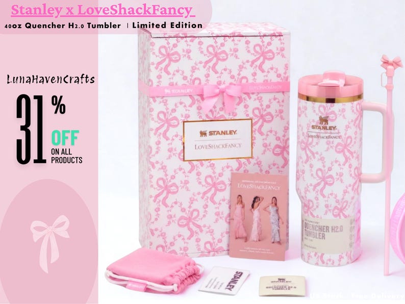 May include: A 40oz Stanley x LoveShackFancy Quencher H2.0 tumbler with a pink ribbon pattern, a matching gift box, a pink drawstring pouch, a small informational card, and a long pink straw with a bow topper, all featuring the Stanley brand logo.